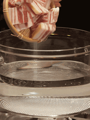 排骨、咸肉，一起下入鍋中，加入蔥，姜，料酒，倒入清水焯水清洗干凈